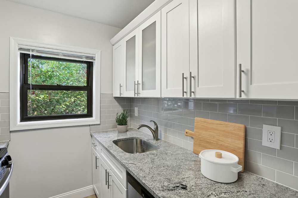 Renovated kitchen with white shaker cabinets at Eagle Rock Apartments at Hicksville/Jericho in Hicksville, New York
