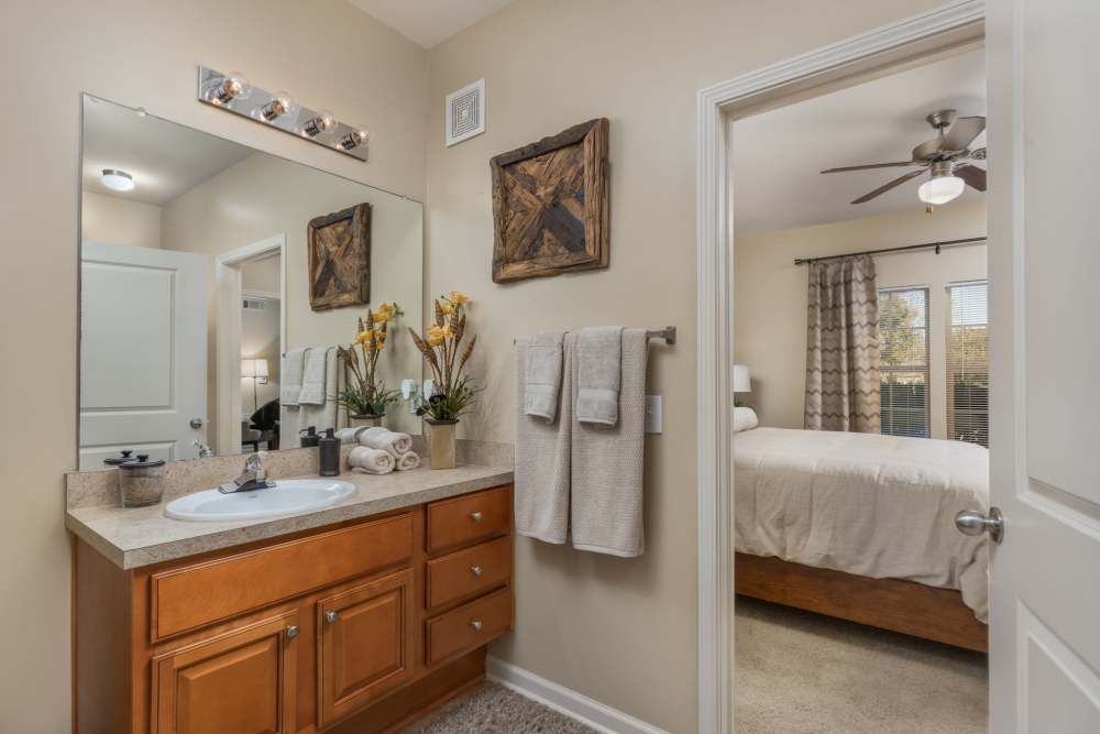 Apartment bathroom with counterspace, storage cabinets. and direct entry from bedroom at Wembly at Overlook in Macon, GA.