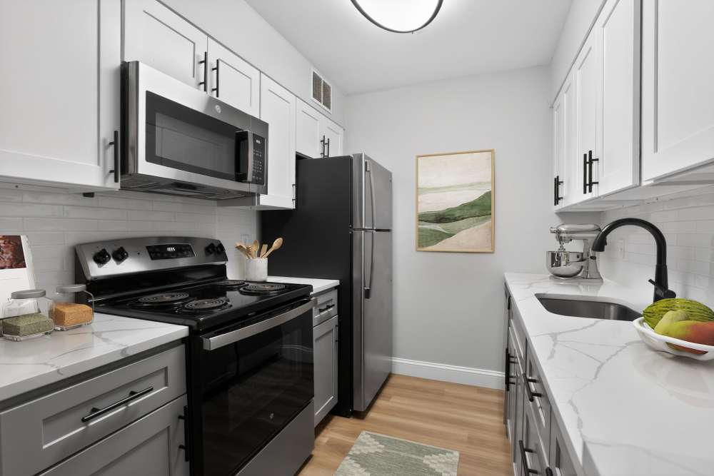 Two-tone kitchen cabinetry at Bay Ridge at Nashua Apartments in Nashua, New Hampshire