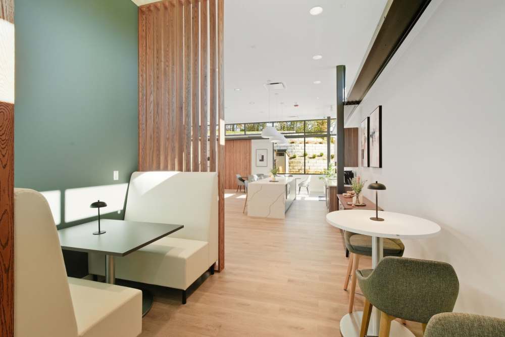 Renovated clubhouse with pool table, kitchen, and dining area, coming soon at Eagle Rock Apartments at Woodbury in Woodbury, New York