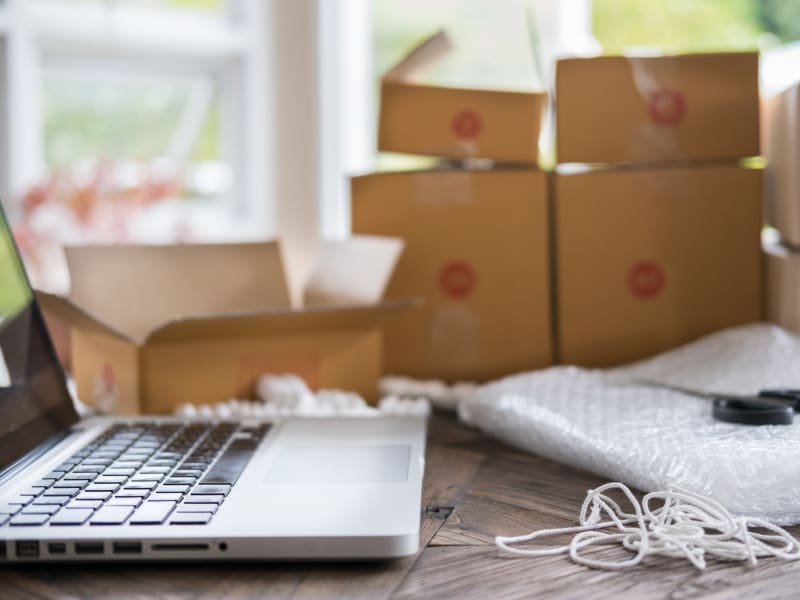 A laptop next to packing supplies from 603 Storage - Lee in Lee, New Hampshire