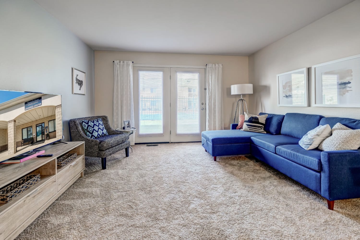 Living room opening onto a private patio at Steeplechase Apartments & Townhomes in Toledo, Ohio