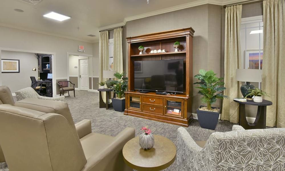 Entertainment room with comfortable seating at Foxberry Terrace Senior Living in Webb City, Missouri