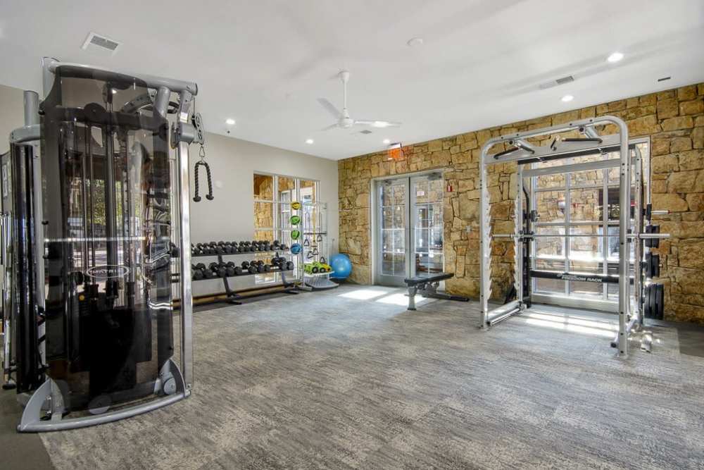 Fitness studio with weight machines at Flatiron District at Austin Ranch in The Colony, Texas