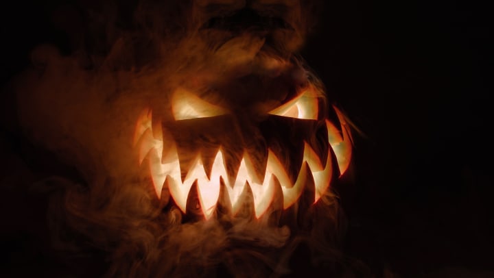 A spooky smoking pumpkin lurking in the shadows near Olympus Waterford