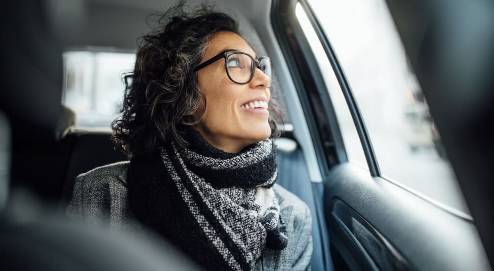 Woman looking out the window while getting a ride to work near Crystal Springs in Fort Worth, Texas