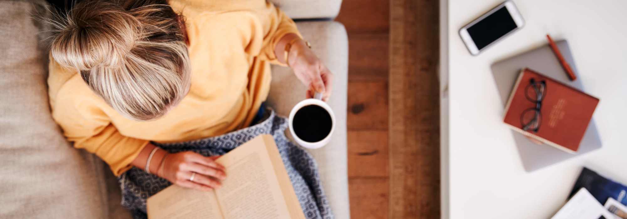 A woman having a relaxing time on the couch | Amenities at Ventura Park Plaza Apartments in Portland, Oregon