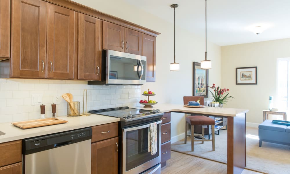 A kitchen with wood flooring in an apartment at Touchmark on West Century in Bismarck, North Dakota