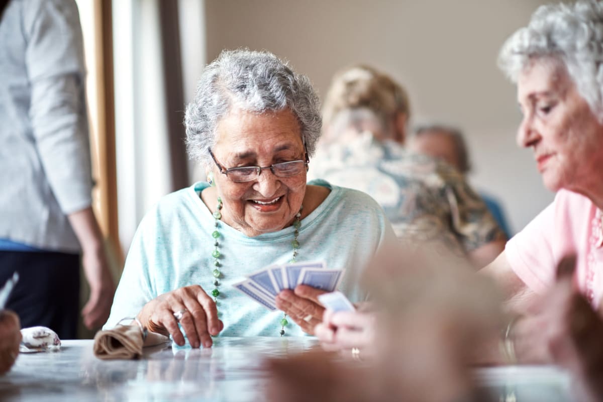 Resident playing cards at MuirWoods Memory Care in Petaluma, California