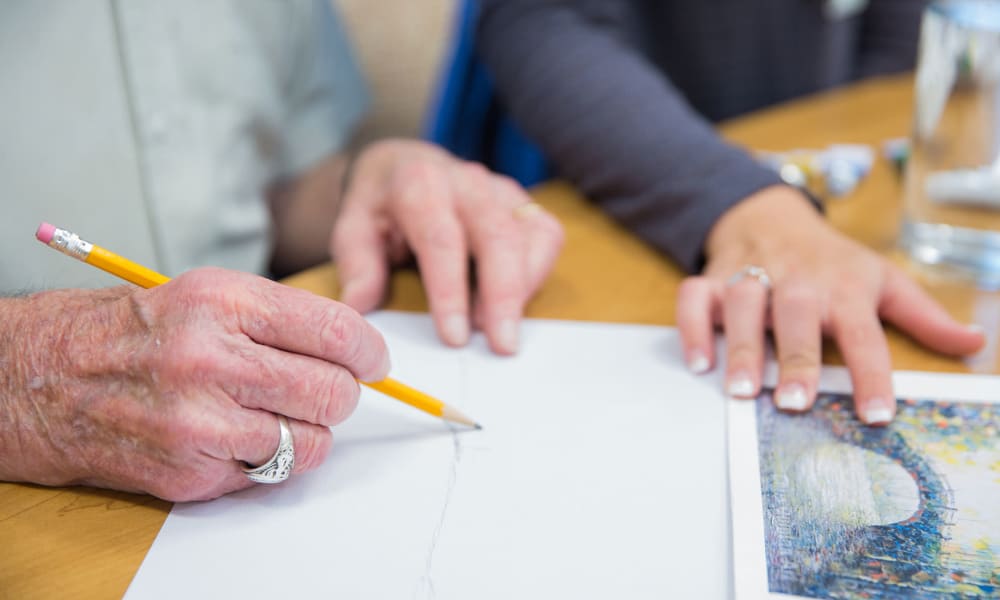 A resident practices pencil drawing at Touchmark on Saddle Drive in Helena, Montana