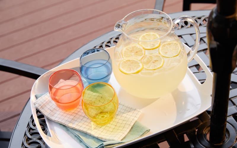 A pitcher of lemonade and glasses on a patio table at Amira Choice Plymouth in Plymouth, Minnesota