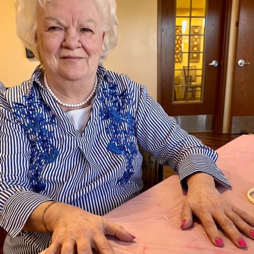 Beaming resident holding a craft at The Oxford Grand Assisted Living & Memory Care in McKinney, Texas