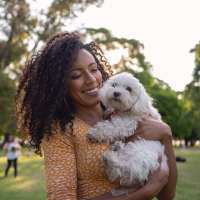 Resident cuddling her pet at The Victorian in Dallas, Texas