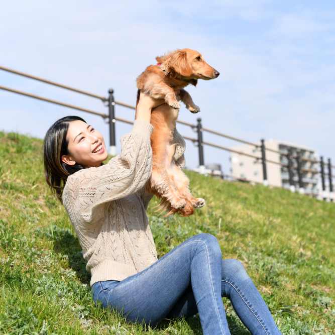 Resident and her pet in a park at The Baldwin in Orlando, Florida