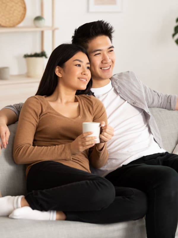 Happy couple sitting on the couch at Paxton Place, Madison, Alabama