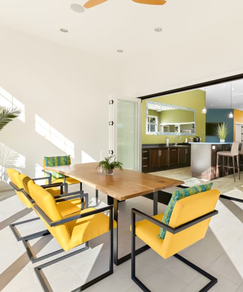 Modern Dining Area with a Wooden Table and Six Yellow Chairs at Arbor Brook in Murfreesboro, Tennessee
