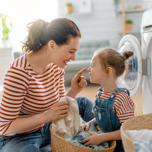 A mother and daughter doing laundry in a home at Bradford Cove in Virginia Beach, Virginia