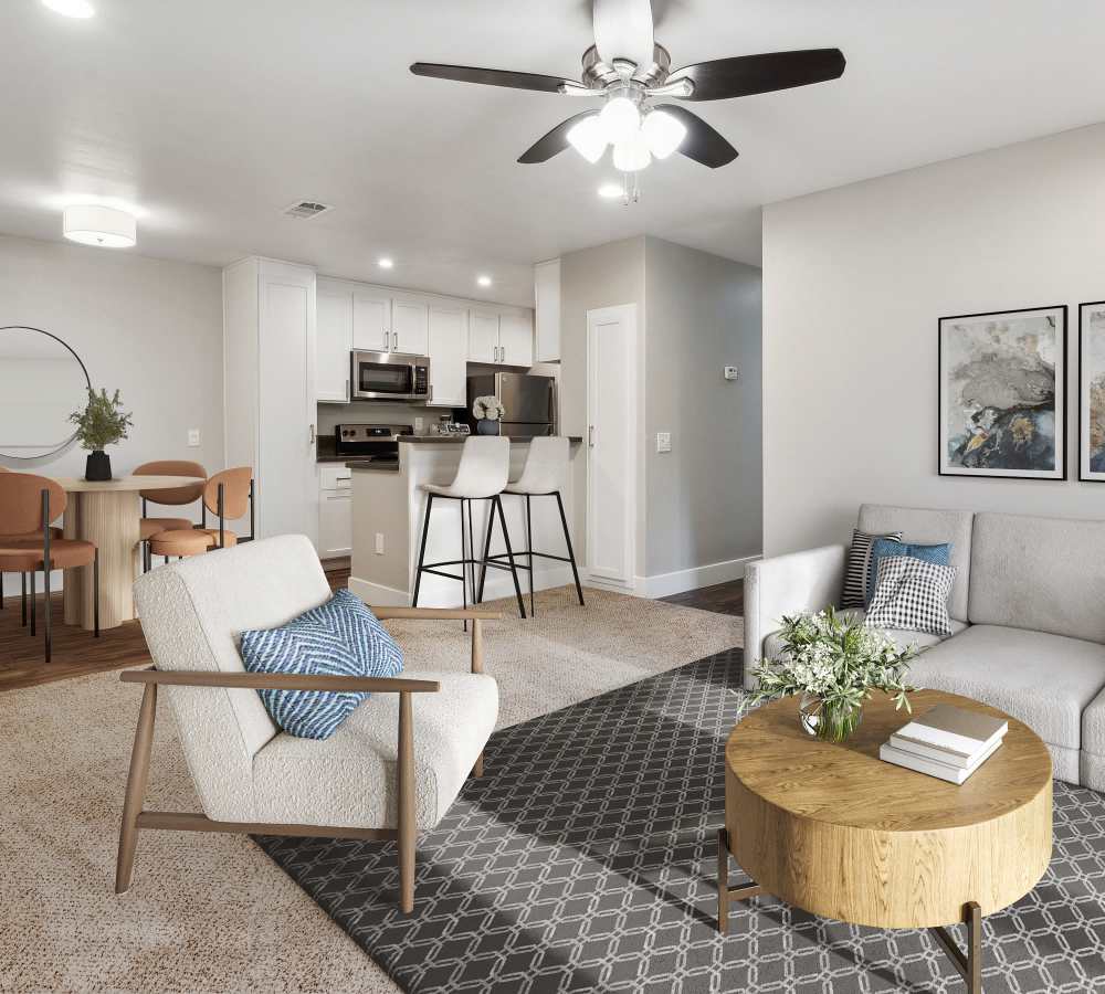 Living room, dining room and kitchen with white cabinets and stainless steel appliances at Muirwood Apartment Homes in Martinez, California