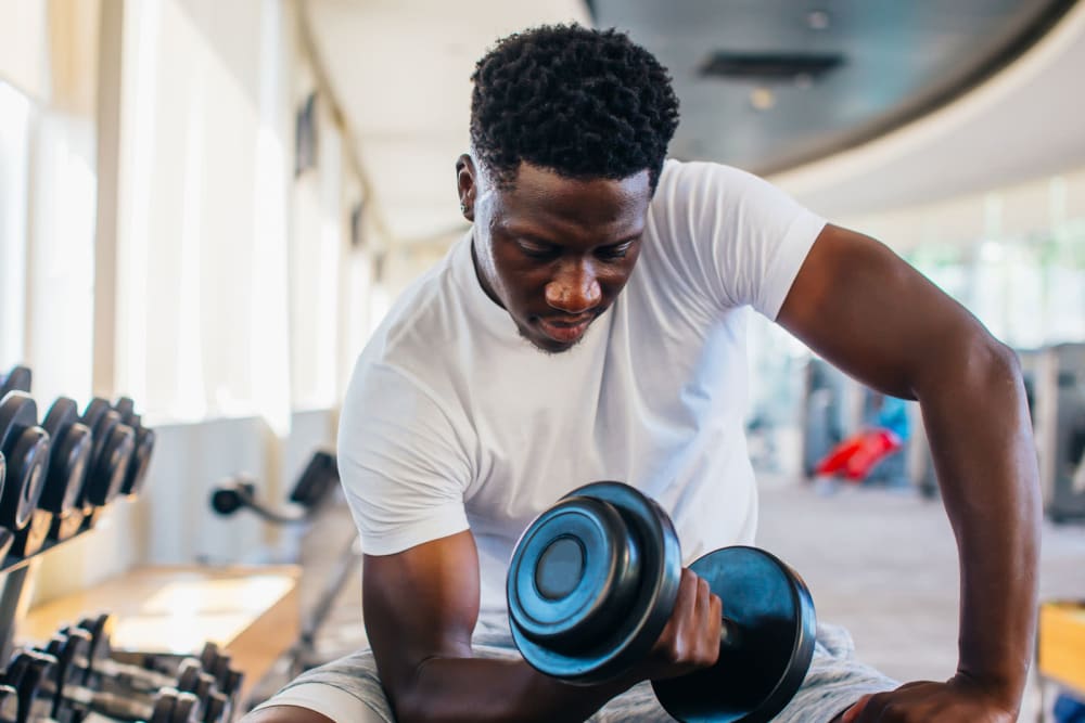 Resident staying in shape in the fitness center at Palmetto Pointe in San Antonio, Texas