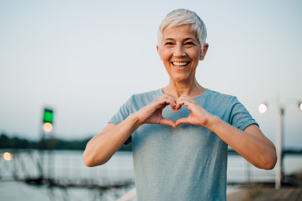 Senior holding her hands in the shape of a heart in Gig Harbor, WA