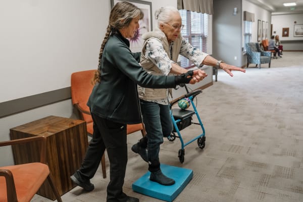 Our resident being assisted with recreational activity at Highline Place by our staff