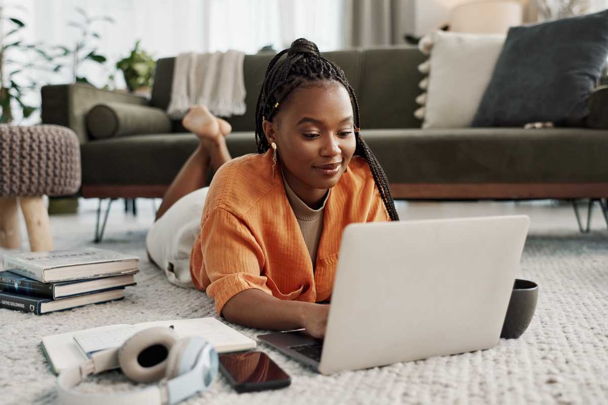 Resident working in her laptop in the living area at Cherokee Summit Apartments in Acworth, Georgia