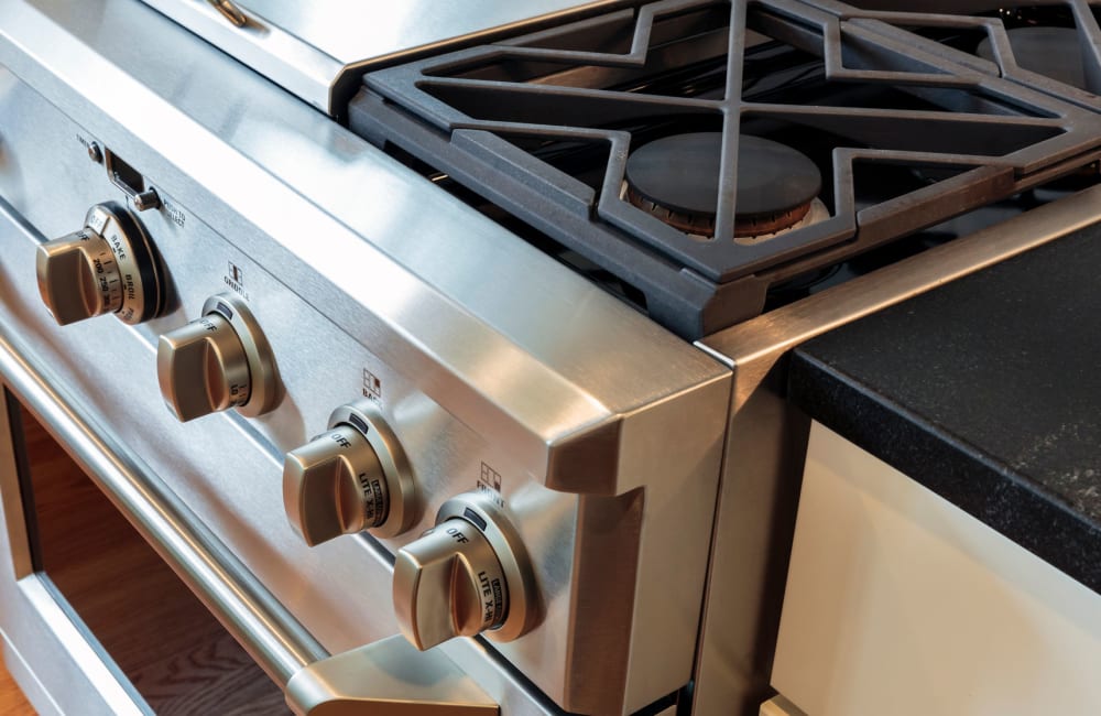 Stainless-steel gas range in a model home's kitchen at Mariposa at Ella Boulevard in Houston, Texas