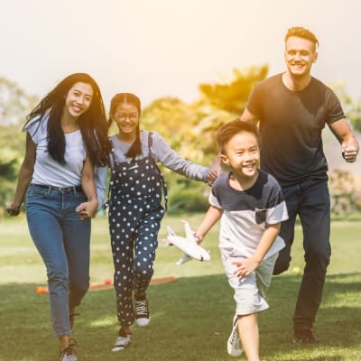 A family playing at a park near Meriwether Landing in Joint Base Lewis McChord, Washington