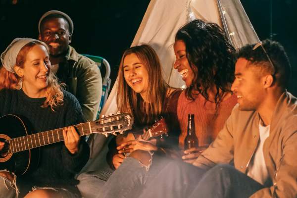 Residents in a campfire playing guitar near Dawson in Orlando, Florida