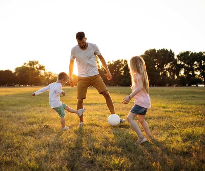 Resident with his kids playing in a park near The Glen at Kensington in Kensington, Maryland