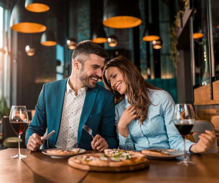 Couple enjoying food at a restaurant near Valencia Park in Orlando, Florida
