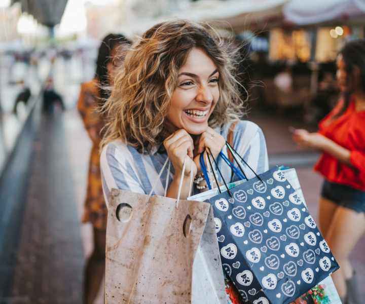 Resident holding shopping bags near Banyan Club East in Pompano Beach, Florida 