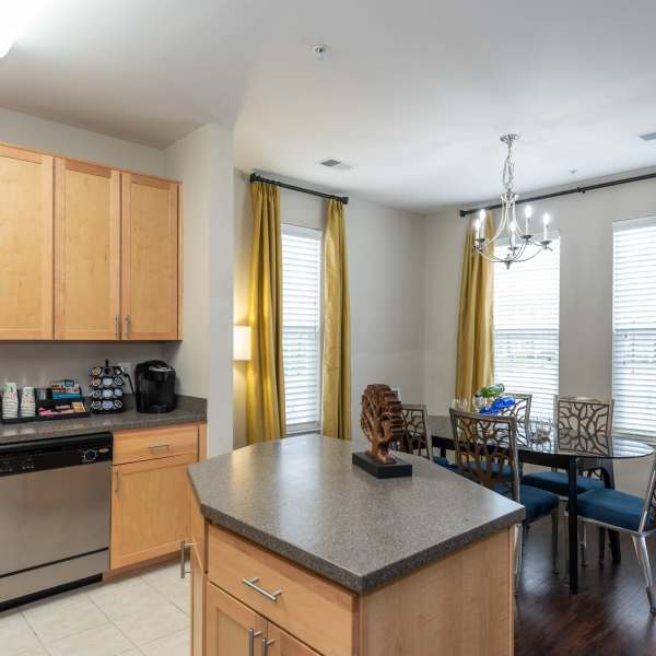 A kitchen and dining area in an apartment at Commons on Potomac Square, Sterling, Virginia