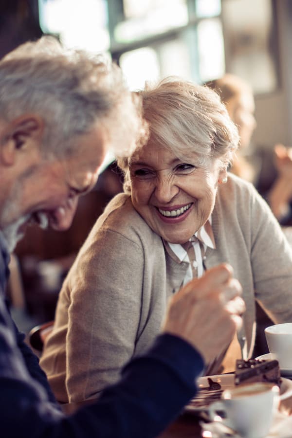 Couple enjoying some coffee together while they laugh and chat at Mark at West Midtown in Atlanta, Georgia