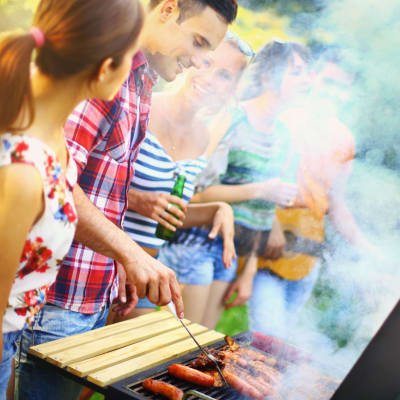 Residents barbequing food during a community event at Perry Circle Apartments in Annapolis, Maryland