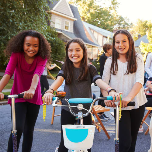 Resident children on bicycles and scooters at a community event at Bradford Cove in Virginia Beach, Virginia