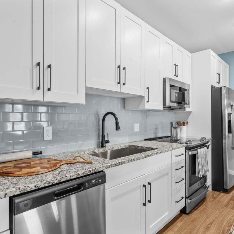 Ultra-modern kitchen with a granite countertop at North Bay Landing in Panama City, Florida