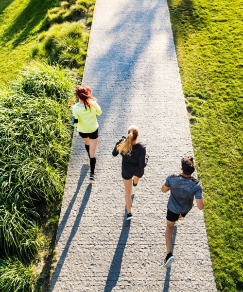 Residents running through a park near Villagio Luxury Apartments in Sacramento, California