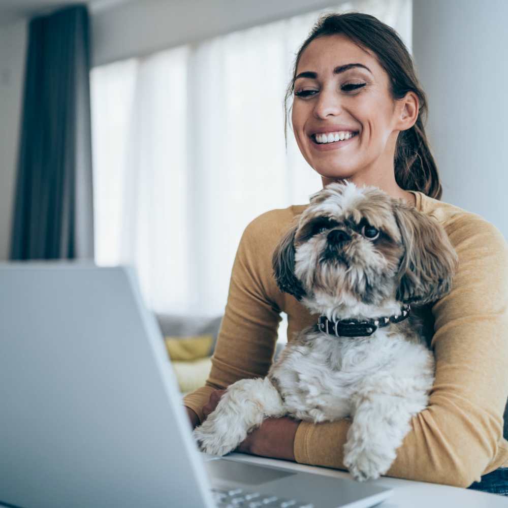Resident with a dog in her lap at Columbine Apartments in Littleton, Colorado