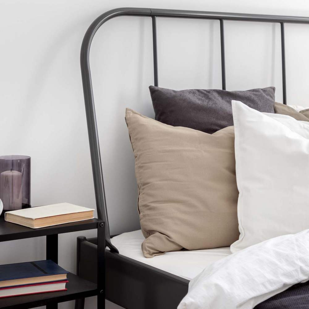 Comfortably decorated bed at Los Flamboyanes in Rochester, New York