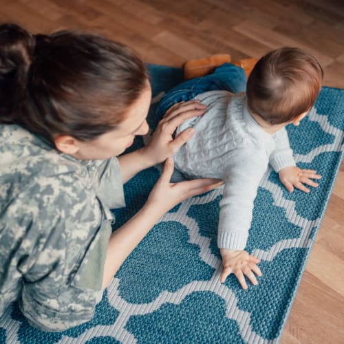 A military resident and her son in a home at Fairway Heights in Twentynine Palms, California