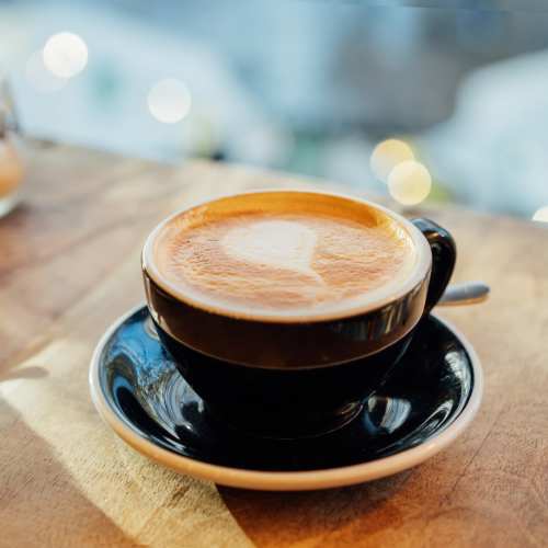A coffee cup placed on a table in a cafe near Broadway Crossing Apartments in Merrillville, Indiana