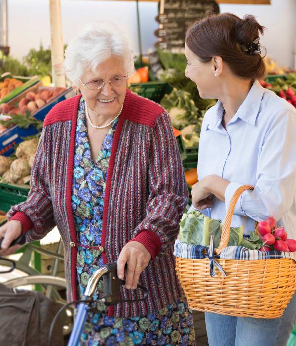 A resident and caretaker shopping at the grocery store near The Phoenix at Greer in Greer, South Carolina
