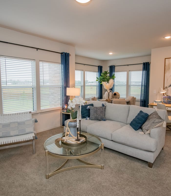 Carpeted living room at Redbud Ranch Apartments in Broken Arrow, Oklahoma