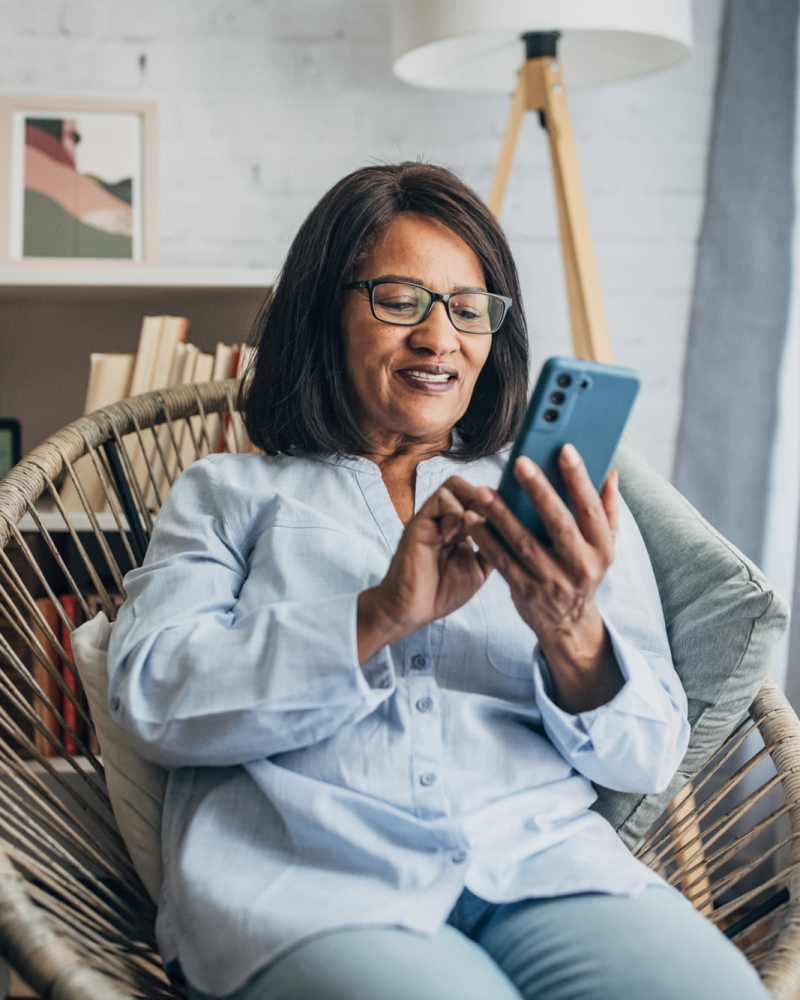 Resident using her mobile phone at CSI Mini Storage Richmond in Richmond, California.