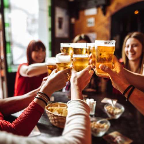 A group of residents having a toast in a bar near Bristle Pointe Apartments in Reno, Nevada