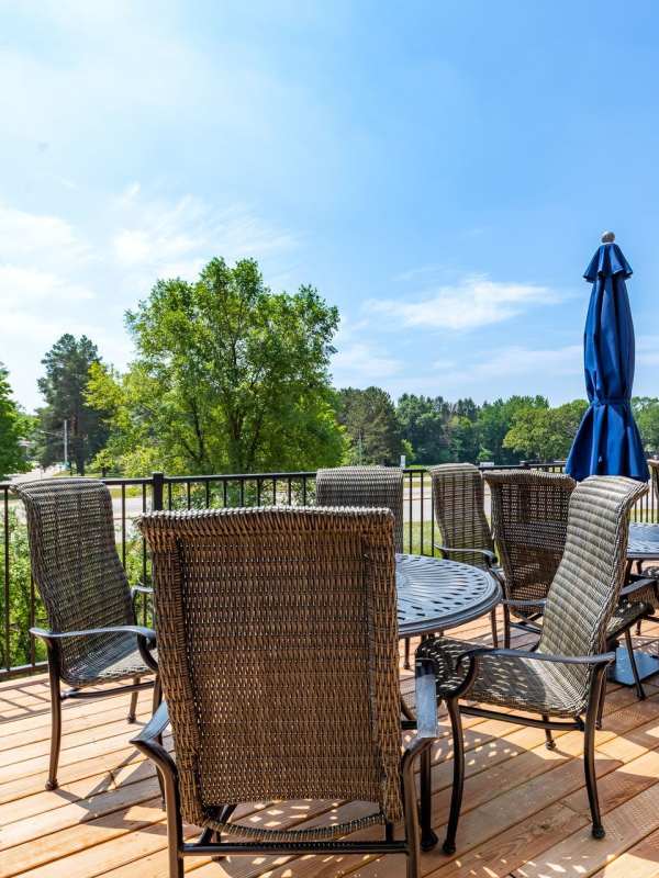 Tables and chairs on the community deck at Glenfield Park Estates in Blaine, Minnesota