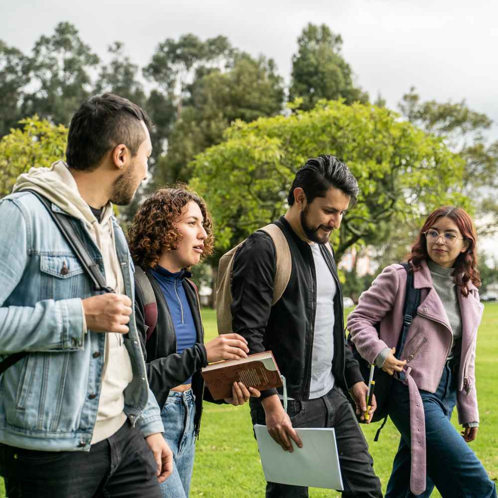 Friends greeting each other on campus near Titan Court in Eugene, Oregon