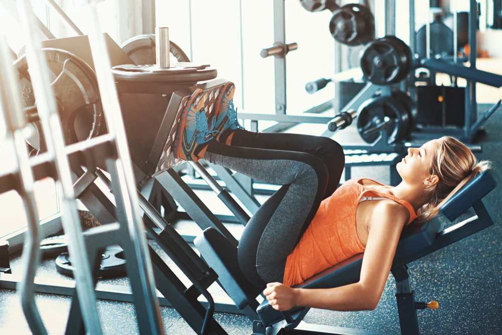 Woman working out in gym near The Current Apartments in Biloxi, Mississippi