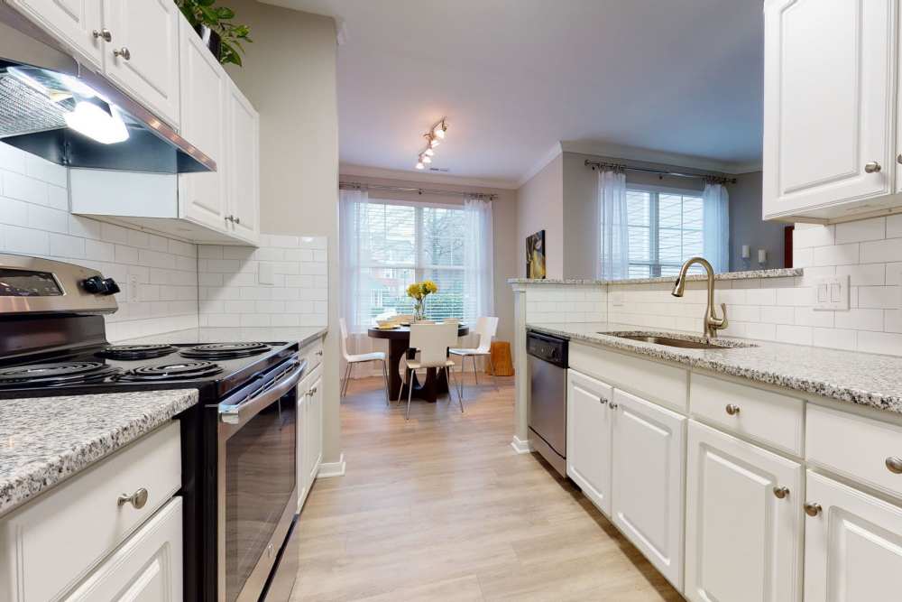 Fully equipped kitchen with connecting dining space at Wesley in Raleigh, North Carolina